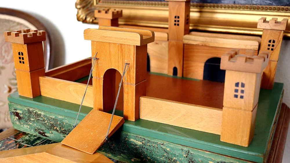 A wooden toy castle with a drawbridge. Representative photo, not the exact product.