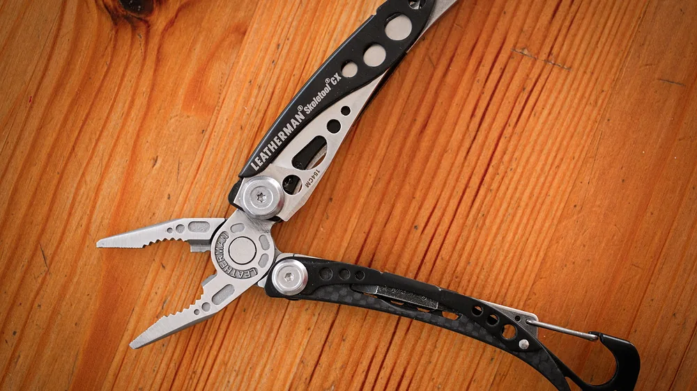 Leatherman Skeletool CX multitool open on a wooden surface