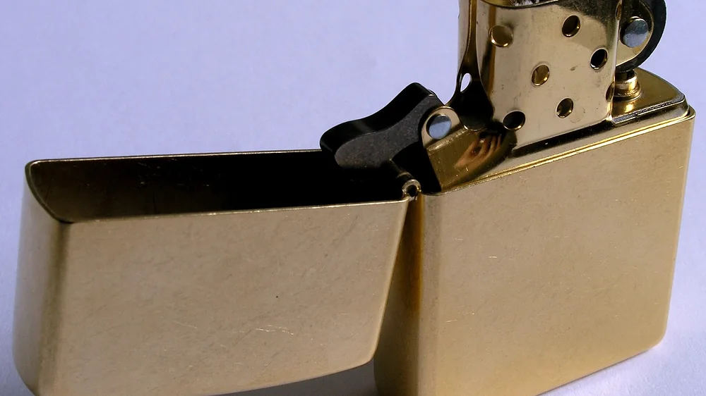 Open brass Zippo windproof lighter with its insert showing